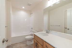 Bathroom featuring visible vents, vanity, toilet, recessed lighting, and shower / washtub combination