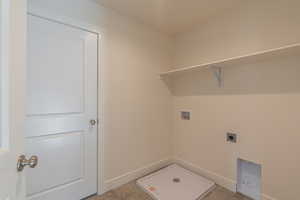 Laundry area featuring electric dryer hookup, laundry area, washer hookup, and baseboards