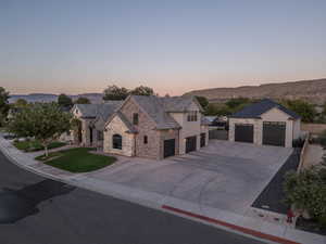 View of front of property with a garage and a mountain view