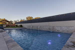 Pool at dusk with a gazebo