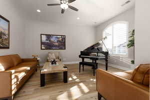 Sitting room with light hardwood / wood-style flooring and ceiling fan