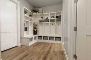 Mudroom with light hardwood / wood-style flooring