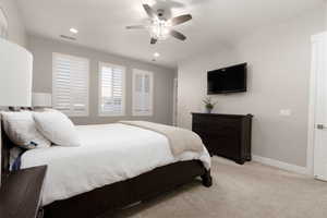 Bedroom featuring light carpet and ceiling fan