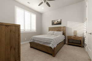 Bedroom featuring light carpet and ceiling fan