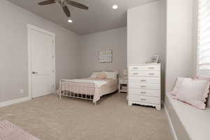 Carpeted bedroom with ceiling fan