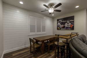 Dining area with dark wood-type flooring and ceiling fan