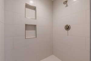 Bathroom featuring a tile shower