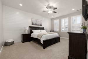 Bedroom featuring light carpet and ceiling fan