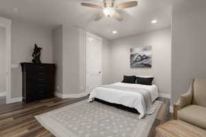 Bedroom featuring ceiling fan and dark hardwood / wood-style floors