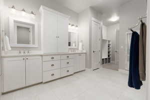 Bathroom with tile patterned floors and vanity