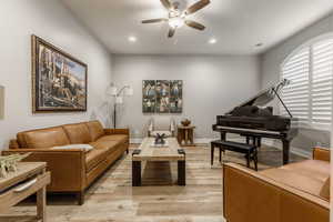 Sitting room featuring ceiling fan and light hardwood / wood-style flooring