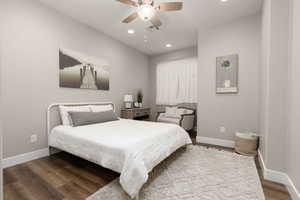 Bedroom with ceiling fan and hardwood / wood-style floors