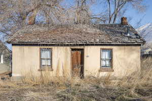 View of side of home with a mountain view