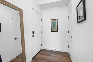 Hall featuring dark wood-type flooring