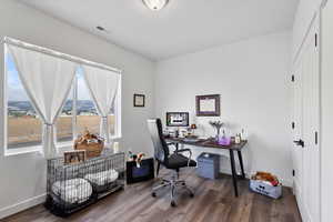 Office with hardwood / wood-style floors