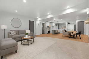 Living area with recessed lighting and light wood-style flooring