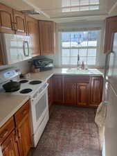 Kitchen featuring sink and white appliances