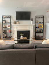 Living room with crown molding and light hardwood / wood-style flooring