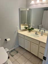 Bathroom with tile patterned flooring, vanity, and toilet