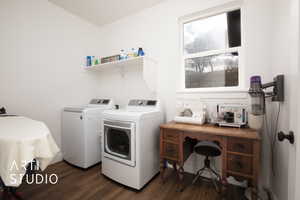 Laundry area with dark hardwood / wood-style floors and washer and dryer