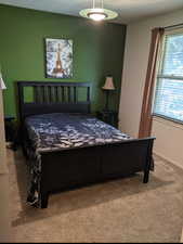 Bedroom featuring multiple windows and carpet floors