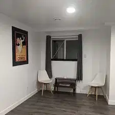 Sitting room with dark hardwood / wood-style flooring