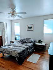 Bedroom with hardwood / wood-style flooring and ceiling fan