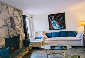 Living room with a stone fireplace