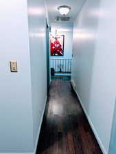 Hallway with dark wood-type flooring