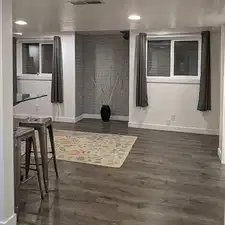 Living room featuring dark hardwood / wood-style floors and brick wall