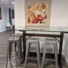 Bar featuring dark hardwood / wood-style floors