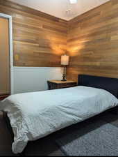 Bedroom with wooden walls