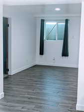 Unfurnished room featuring dark wood-type flooring