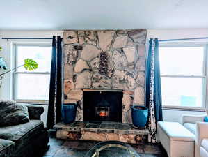 Living room featuring a stone fireplace
