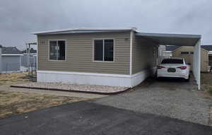 View of property exterior featuring a carport