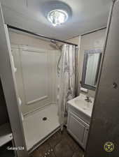 Bathroom featuring vanity, tile patterned flooring, and a shower with curtain