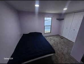 Unfurnished bedroom with carpet floors and a closet