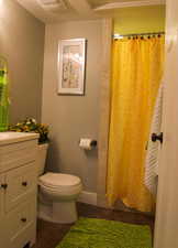 Bathroom featuring vanity, hardwood / wood-style floors, curtained shower, and toilet