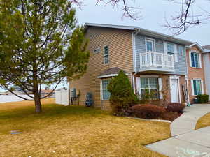 View of front with a beautiful balcony and a front lawn