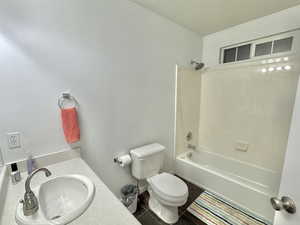 2nd floor Full bathroom with sink, stone floors, toilet, and shower / washtub combination