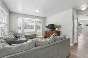 Living room featuring LVP, bay window for extra light