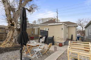 Rear view of house featuring a patio area(Backyard Remodeled with flowering bushes and plants, gravel and pavers.  Tree is maintained with pruning.)