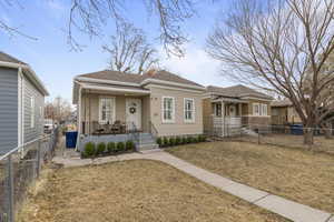 View of front of property with a porch and a front lawn