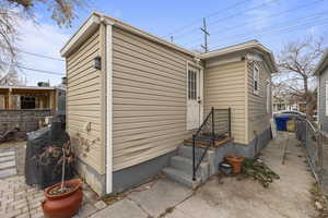 View  of Backdoor (to the Kitchen),Backyard Remodeled with flowering bushes and plantsof side of home