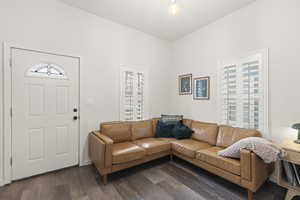 Living room with dark wood-type flooring