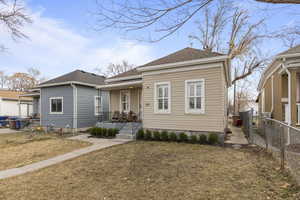 Bungalow-style home with a front lawn and covered porch