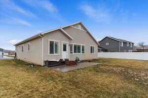 Back of house featuring a yard and a patio area