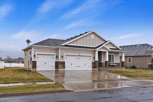 Craftsman-style home with a garage and a front lawn