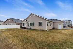 Rear view of house featuring cooling unit, a patio area, and a lawn