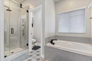 Bathroom featuring toilet and plus walk in shower